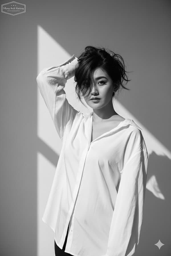 A portrait photo wearing a loose white shirt